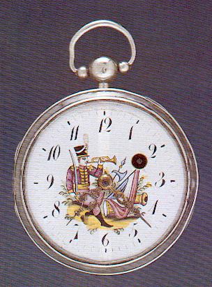 Montre du début du 19ème siècle. Cadran émaillé peint représentant divers symboles de l'empire : soldat napoléonien sonnant du clairon, canon, tambour, drapeau tricolore et hallebarde.  Collection privée.